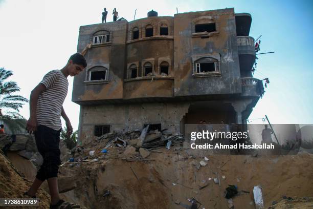 Palestinian citizens inspect their home destroyed during Israeli air raids in the southern Gaza Strip on October 16, 2023 in Khan Yunis, Gaza. Gazans...