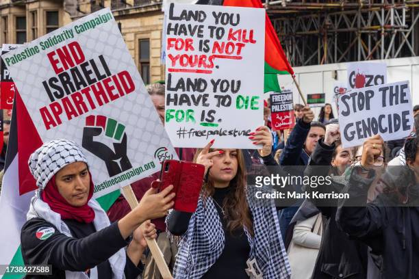 Pro-Palestinian protesters march through central London in support of the Palestinian population of Gaza on 21st October 2023 in London, United...