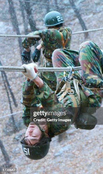 Hanging Rope Army Students hang on the ropes during a training course for civilians ...