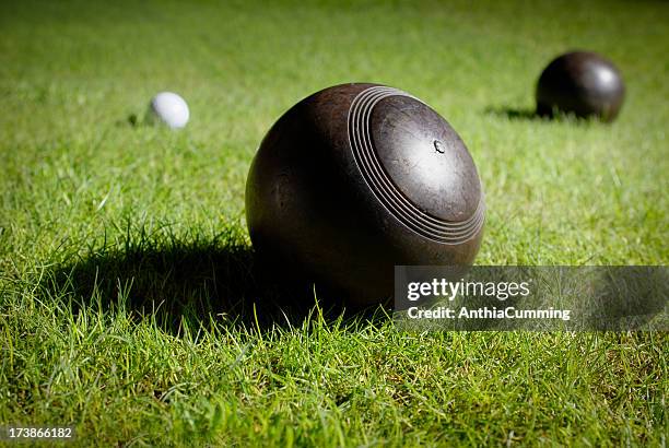 wooden lawn bowls on a bowling green around jack - lawn bowls stock pictures, royalty-free photos & images