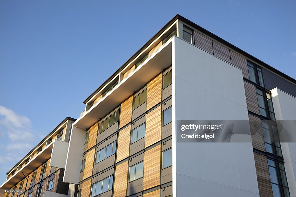 Residential Apartment with wood panels and blue clear sky