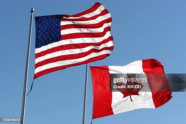 flags - canada v united states stock pictures, royalty-free photos & images