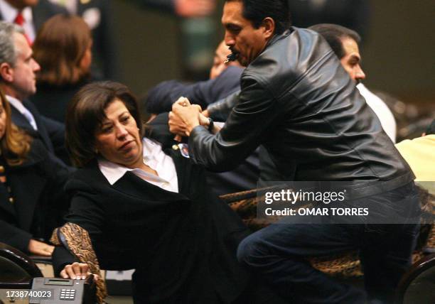 Unidentified Mexican deputies from the Partido Accion Nacional and Partido de la Revolucion Democratica struggle at the Congress before the new...