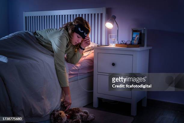 teenage girl suffering insomnia - bedside table kid asleep stock pictures, royalty-free photos & images