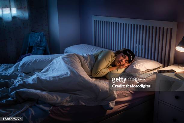 teenage girl suffering insomnia fell asleep in bed - bedside table kid asleep stock pictures, royalty-free photos & images