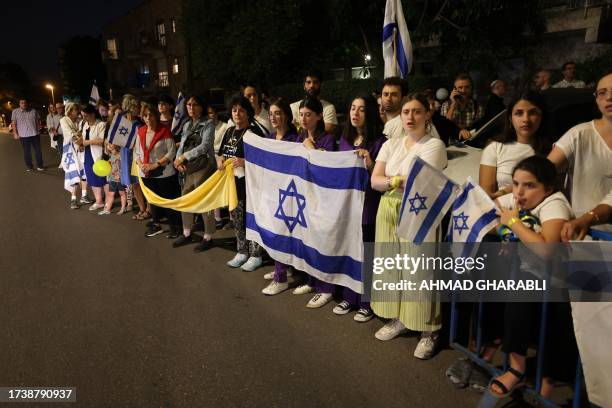 Demonstrators holding the Israeli flag and a yellow ribbon rally calling for the release of Israeli hostages held by the Palestinian Hamas militants...