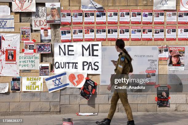 Relatives hang banners and photos of their relatives, who are held captive, as they gather to demand that the government take action to secure the...