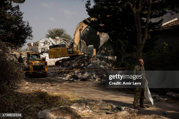 Members of Army rescue and ZAKA crews search for bodies and body parts after the Hamas and Palestinians militants attack on the Kibbutz on October...