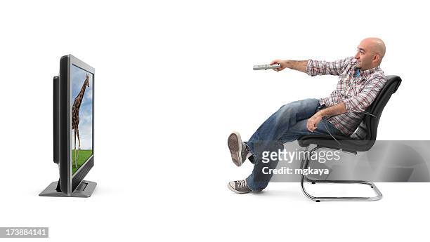 a man watching television with a remote  - armchair isolated stock pictures, royalty-free photos & images