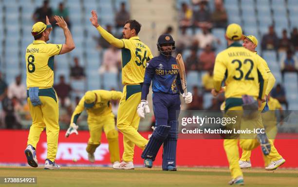 Mitchell Starc of Australia celebrates the wicket of Dhananjaya de Silva of Sri Lanka during the ICC Men's Cricket World Cup India 2023 between...