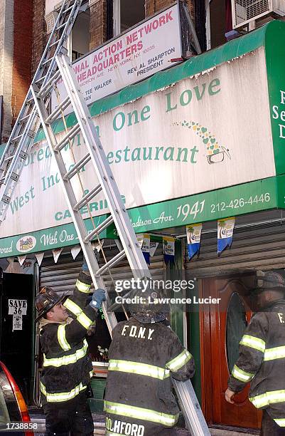 Firefighters work on the scene of a fire at the Harlem headquarters of Democratic Presidential candidate and activist Rev. Al Sharpton January 22,...