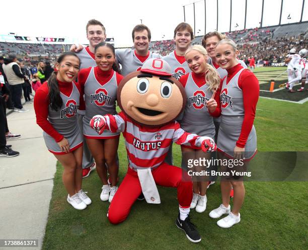 Members of the Ohio State Buckeyes cheerleading team pose for a photo with Buckeyes mascot Brutus Buckeye before the Ohio State Buckeyes versus the...