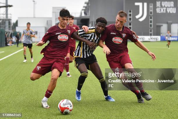 Karamoko Kaba of Juventus U16 is challenged during the match between Juventus U16 and Torino U16 at Juventus Center Vinovo on October 22, 2023 in...
