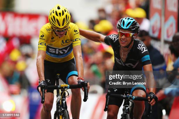 Chris Froome of Great Britain and Team Sky Procycling and team mate Richie Porte of Australia cross the finish line together at the end of stage...