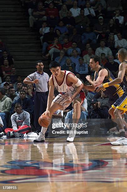 Yao Ming of the Houston Rockets dribbles against Jeff Foster of the Indiana Pacers during the game at Compaq Center on December 18, 2002 in Houston,...