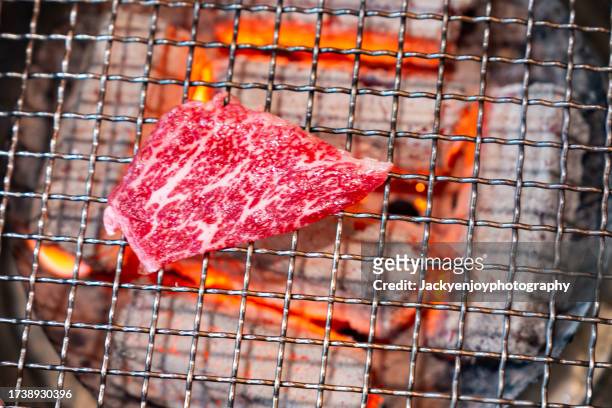 grilling raw beef on a korean barbecue grill - multi fuel stoves stock pictures, royalty-free photos & images