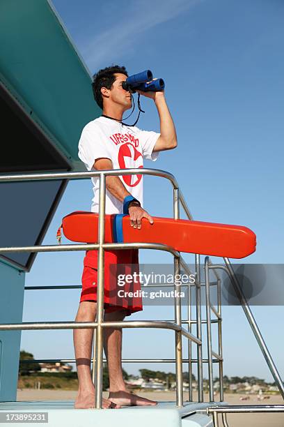 lifeguard looking through binoculars - badmeester stockfoto's en -beelden