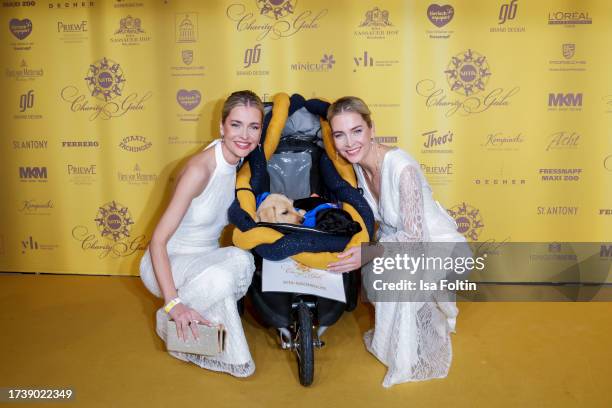 Nina Meise and Julia Meise and dog babys attend the VITA Charity Gala on October 14, 2023 in Wiesbaden, Germany.