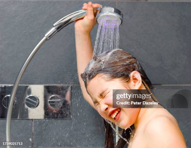 girl washing hair in shower - bathroom home people shower stock pictures, royalty-free photos & images