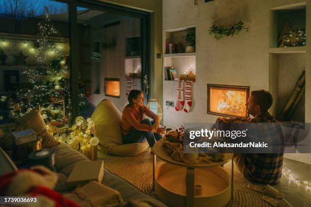 magic moments on christmas eve - outdoor fireplace home stock pictures, royalty-free photos & images