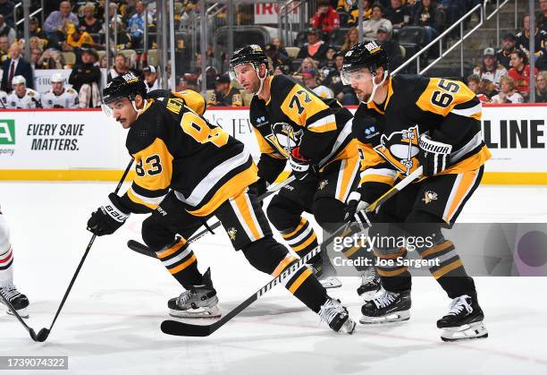 Matt Nieto Jeff Carter and Erik Karlsson of the Pittsburgh Penguins skate against he Chicago Blackhawks at PPG PAINTS Arena on October 10, 2023 in...