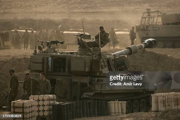 Soldiers sit on an artillery unity near the Israeli border with the Gaza Strip an injured one man on October 22, 2023 in Netivot, Israel. As Israel...