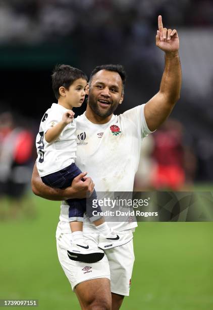 Billy Vunipola of England, carries his son Judah as they celebrate with the crowd after their victory during the Rugby World Cup France 2023 Quarter...