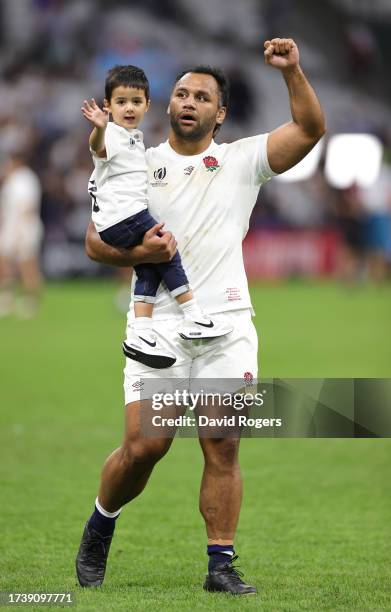 Billy Vunipola of England, carries his son Judah as they celebrate with the crowd after their victory during the Rugby World Cup France 2023 Quarter...