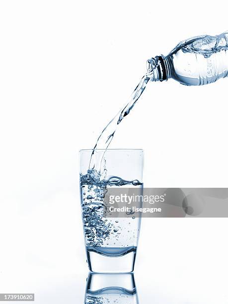 pouring glass of water - pouring stock pictures, royalty-free photos & images