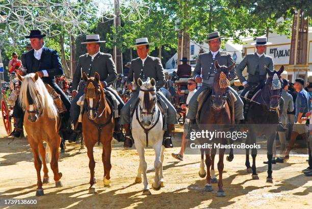 most elegant andalusian horse riders parade. - feria de abril stock pictures, royalty-free photos & images