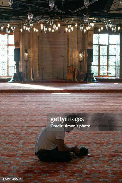 a believer prays in the blue mosque - gelovige stockfoto's en -beelden