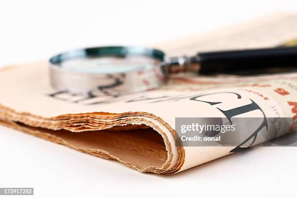 analyzing news - magnifying glass newspaper watching finance stock market and exchange stock pictures, royalty-free photos & images