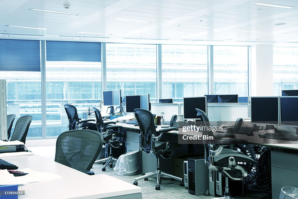 Empty Office Interior With Chairs, Computers, Desktops And Blue Windows