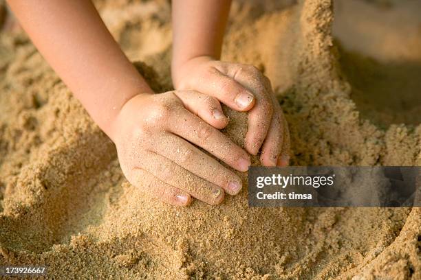 child's hands forming a cone in sand - sandlåda bildbanksfoton och bilder