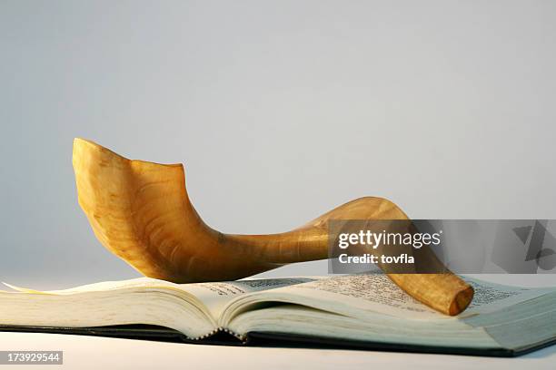 shofar on a bible book at rosh hashanah - shofar stock pictures, royalty-free photos & images