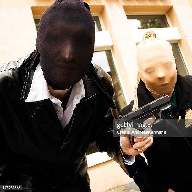 armed robbers posing for a photo wearing masks - bank robber stock pictures, royalty-free photos & images