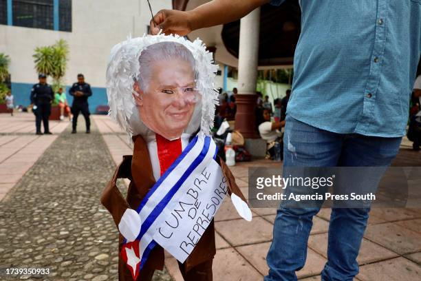 Person shows the figure of the President of Cuba Miguel Díaz Canel on October 22, 2023 in Tapachula, Mexico. On the day of the summit on migration...
