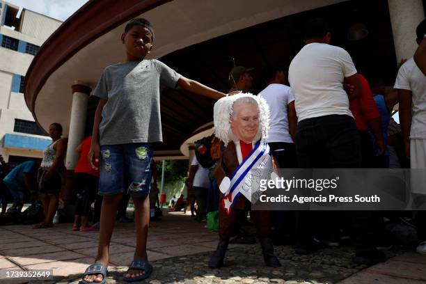 Child shows the figure of the President of Cuba Miguel Díaz Canel on October 22, 2023 in Tapachula, Mexico. On the day of the summit on migration...