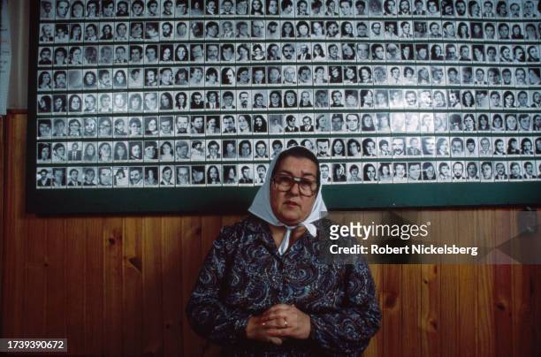 President of the Mothers of the Plaza de Mayo human rights group Hebe de Bonafini stands in front of a wall of photograph of disappeared civilians,...
