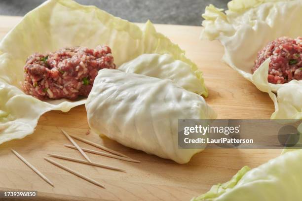 making stuffed cabbage rolls - stuffed cabbage stock pictures, royalty-free photos & images