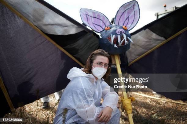 Protester poses in front of a bat in papier-mache. Nearly 10 000 people participated to a week end of action called 'Ramdam sur le Macadam' in the...