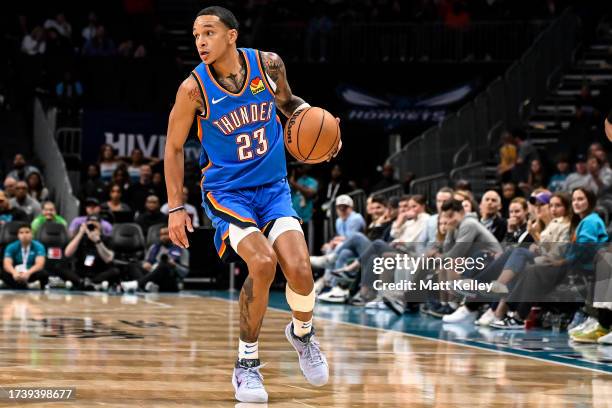 Tre Mann of the Oklahoma City Thunder brings the ball up court during the second half of his game against the Charlotte Hornets at Spectrum Center on...