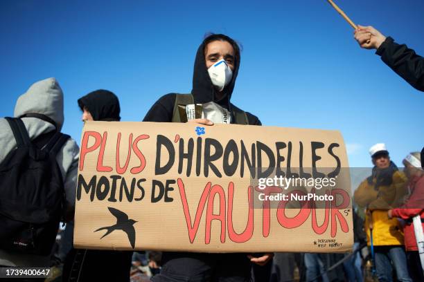 Protester holds a placard reading 'more swallows than vultures'. Nearly 10 000 people participated to a week end of action called 'Ramdam sur le...