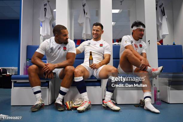 Ollie Lawrence, Danny Care and Marcus Smith of England celebrate in the changing room following the Rugby World Cup France 2023 Quarter Final match...