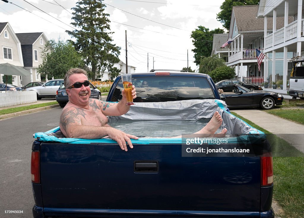 Redneck Swimming Pool, man relaxing in pick-up truck