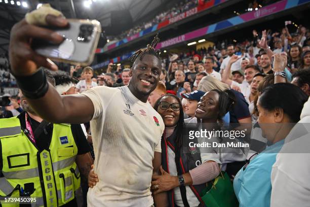 Maro Itoje of England takes a photo with family and friends during the Rugby World Cup France 2023 Quarter Final match between England and Fiji at...