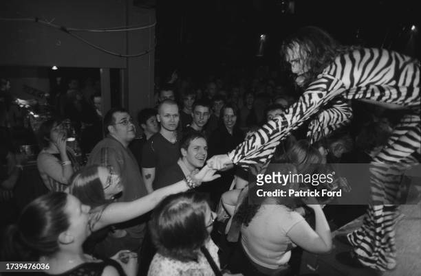 The Darkness Justin Hawkins reaches out to touch hands with members of the audience at Sheffield Leadmill 2003 26th March 2003.