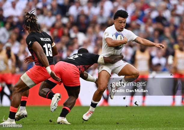 Marcus Smith of England is tackled by Josua Tuisova of Fiji during the Rugby World Cup France 2023 Quarter Final match between England and Fiji at...