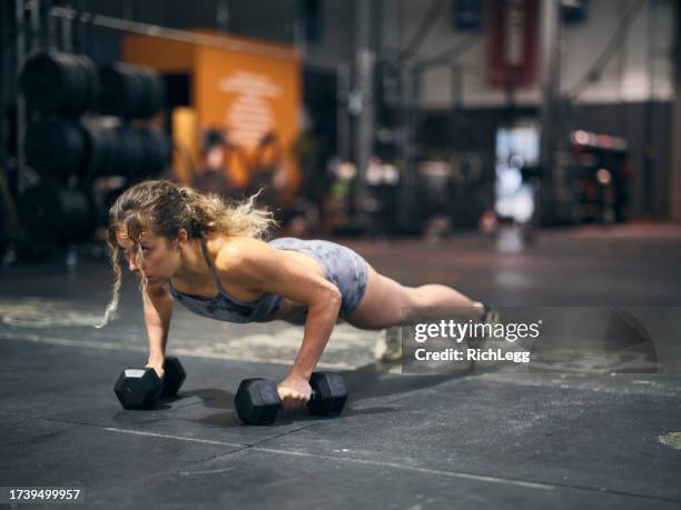 young adult woman cross training in a gym - woman studio stock pictures, royalty-free photos & images