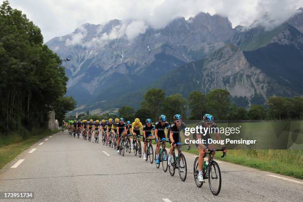 Sky Procycling drive the peloton as they defend the overall race leader's jersey for Chris Froome of Great Britain riding for Sky Procycling during...